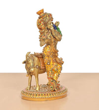 Brass Krishna playing flute on cow, detailed multicolor meenakari finish