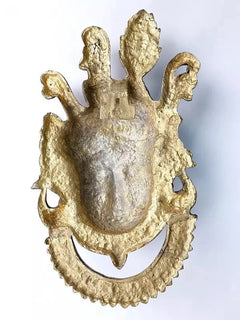 Back-view of brass Shrinathji wall hanging with gold tone finish and looped edges