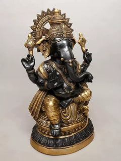 Brass Ganesha statue, angled view with detailed headpiece, ornaments, and hands
