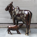 Brass Kamadhenu cow and calf idol, side view with detailed deity figures