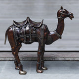 Copper-finish brass camel sculpture, front view, detailed head and engraved saddle panels