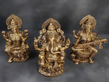 Brass Ganesha center with Lakshmi and Saraswati side idols, seated on lotus