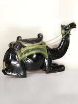 Sitting camel sculpture side view, black finish with green panel saddle and gold chain