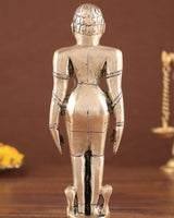 Back view of brass Jain standing statue with detailed robe and base