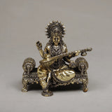 Brass Maa Saraswati sitting sculpture, holding veena on ornate pedestal