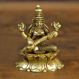 Brass Maa Saraswati seated sculpture with raised hands, ornate detailing