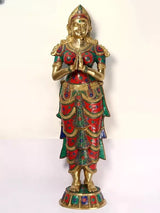 Front view brass Namaste lady sculpture, hands in Anjali mudra, jeweled red and teal outfit
