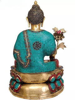 Back view brass medicine Buddha idol with teal robe and red patterned base, holding flower
