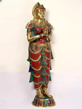 Three-quarter view brass Namaste lady statue, Anjali mudra pose, detailed red teal garment