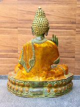 Back view of brass Svarnima Buddha sculpture, detailed crown and engraved robe folds