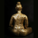 Seated Buddha sculpture in brass leaf mosaic, three-quarter side view with hands in lap