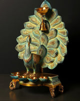Brass peacock oil lamp, detailed feather fan and teal body, front six-cup wick tray