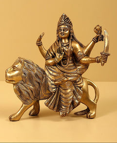 Brass Navadurga idol riding lion, deity with weapons raised and ornate detailing