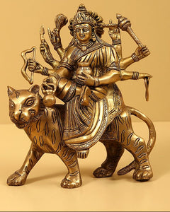Brass Navadurga idol riding bull, seated deity holding staff and trident symbols