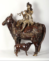 Krishna idol on cow figurine with small calf, dark brown and gold embossed figures
