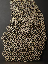 Brass peacock wall decor close-up, spiral swirl cutout feather texture