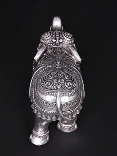 Silver brass elephant figurine, back view showing ornate engraved belly and tail