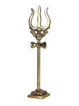 Brass trishul decorative statue with three curved prongs and crossbar, on pedestal.