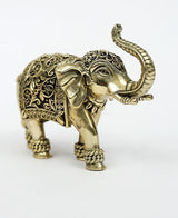 Brass elephant figurine side view, upraised trunk, engraved patterns and studded feet