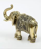 Brass elephant figurine angled view, upraised trunk, detailed carved body and feet