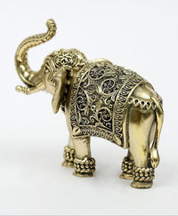 Brass elephant figurine angled view, upraised trunk, detailed carved body and feet