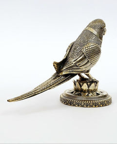 Brass parrot statue, angled side view, ornate feather pattern and lotus base