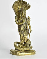 Brass Lord Vishnu statue facing right, standing on coiled snake base