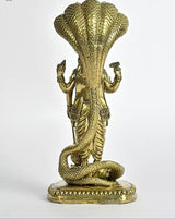 Back view of brass Lord Vishnu idol with ornate crown and coiled snake pedestal