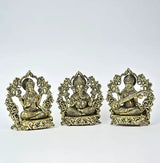 Small brass Lakshmi, Ganesha, and Saraswati seated statues facing front, ornate base