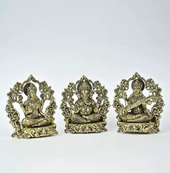 Small brass Lakshmi, Ganesha, and Saraswati seated statues facing front, ornate base