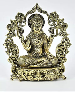 Brass seated deity statue with ornate halo, raised hand, detailed robe and jewelry