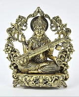 Brass seated Saraswati statue playing veena, ornate halo, patterned sari robe and crown
