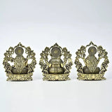 Small brass Lakshmi, Ganesha, and Saraswati statues from behind, ornate back panels, 10 cm