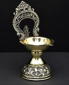 Gold and silver-tone brass diya base with Ganesha idol and sculpted design