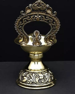 Brass Ganesha diya lamp front view with decorative back arch, 5-inch