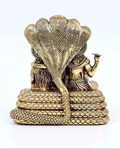 Brass Sheshnag-seated statue, back view with textured coils and raised cobra hood