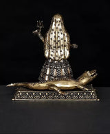 Brass Ganga goddess idol back view on Makara base, flame trident symbol visible