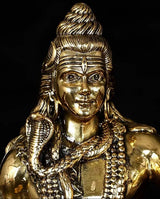 Close-up of Lord Shiva face and long hair on gold-toned brass idol