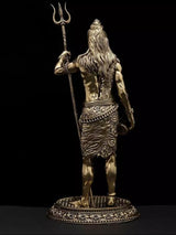 Brass Lord Shiva idol back view, long hair and trident, engraved pedestal base