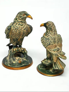 Brass pair of eagle statues, 15 in: one bird facing left on a circular base