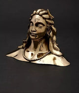 Adiyogi Shiva idol with long hair and pearl necklace, gold-tone patina, side view