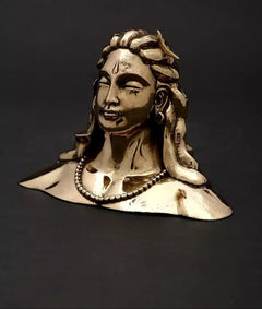 Adiyogi Shiva idol with long hair and pearl necklace, gold-tone patina, side view