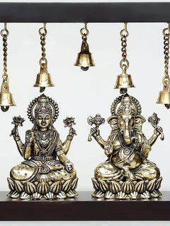 Brass Lakshmi and Ganesha idols seated side by side with five hanging bells