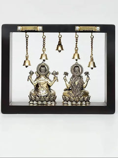 Brass Lakshmi and Ganesha sitting idols with circular headpieces and hanging bells
