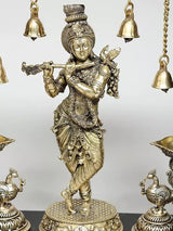 Brass Lord Krishna figurine standing pose with ornate jewelry and hanging bell chains