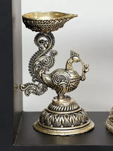 Brass decorative lamp bowl with peacock figure base, part of the Lord Krishna wall hanging