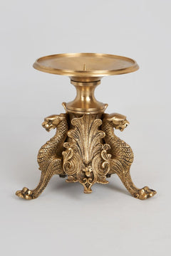 Brass candle holder with two lion figures, round tray top and central candle spike