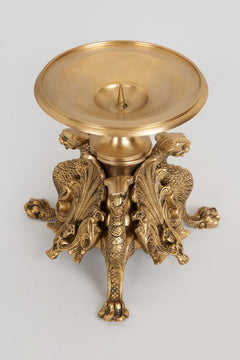 Brass regal candle stand with wide round tray top over lion figure base and candle spike