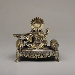 Brass Maa Saraswati seated sculpture with halo, raised hands, veena