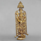 Brass Balaji idol side view with garland drape, ornate arms and beaded halo